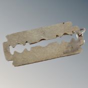 A silver pendant razor blade