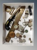 A box of assorted coins, pocket knives, WW II medal, pocket compass in treen pot, brass slide rule,