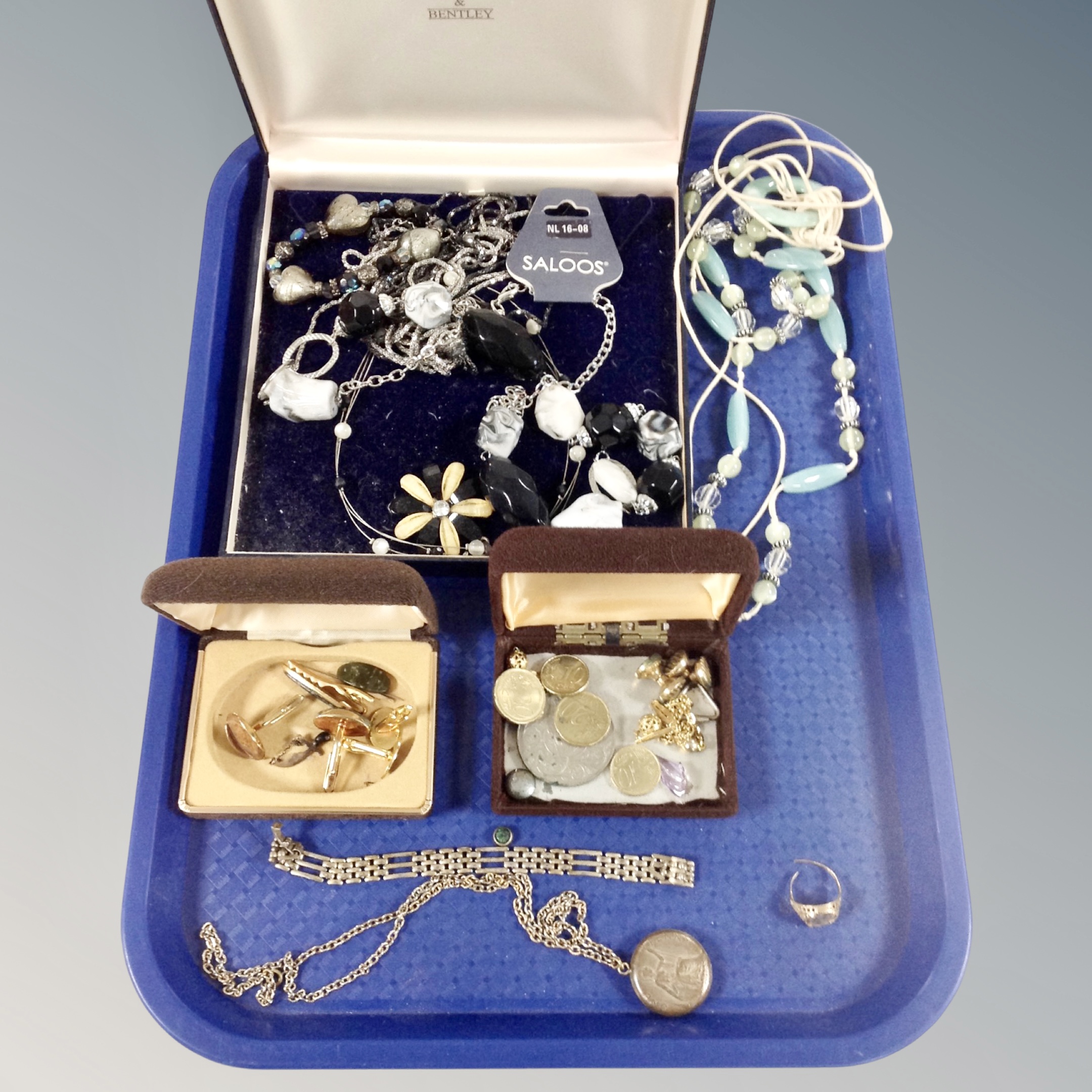A tray of costume jewellery, coins, coin locket on chain,