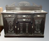 A late 19th century carved mahogany breakfronted sideboard