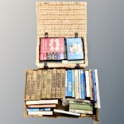 A box and wicker basket containing books and videos relating to fishing,