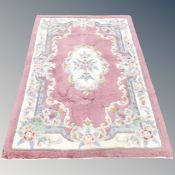 A Chinese floral rug on pink ground