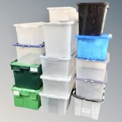 Fourteen plastic storage crates with lids,