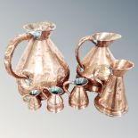 A set of six graduated antique copper jugs