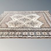 An Eastern carpet of geometric design 375 cm x 283 cm