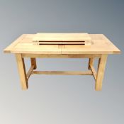 A contemporary oak dining table with two leaves