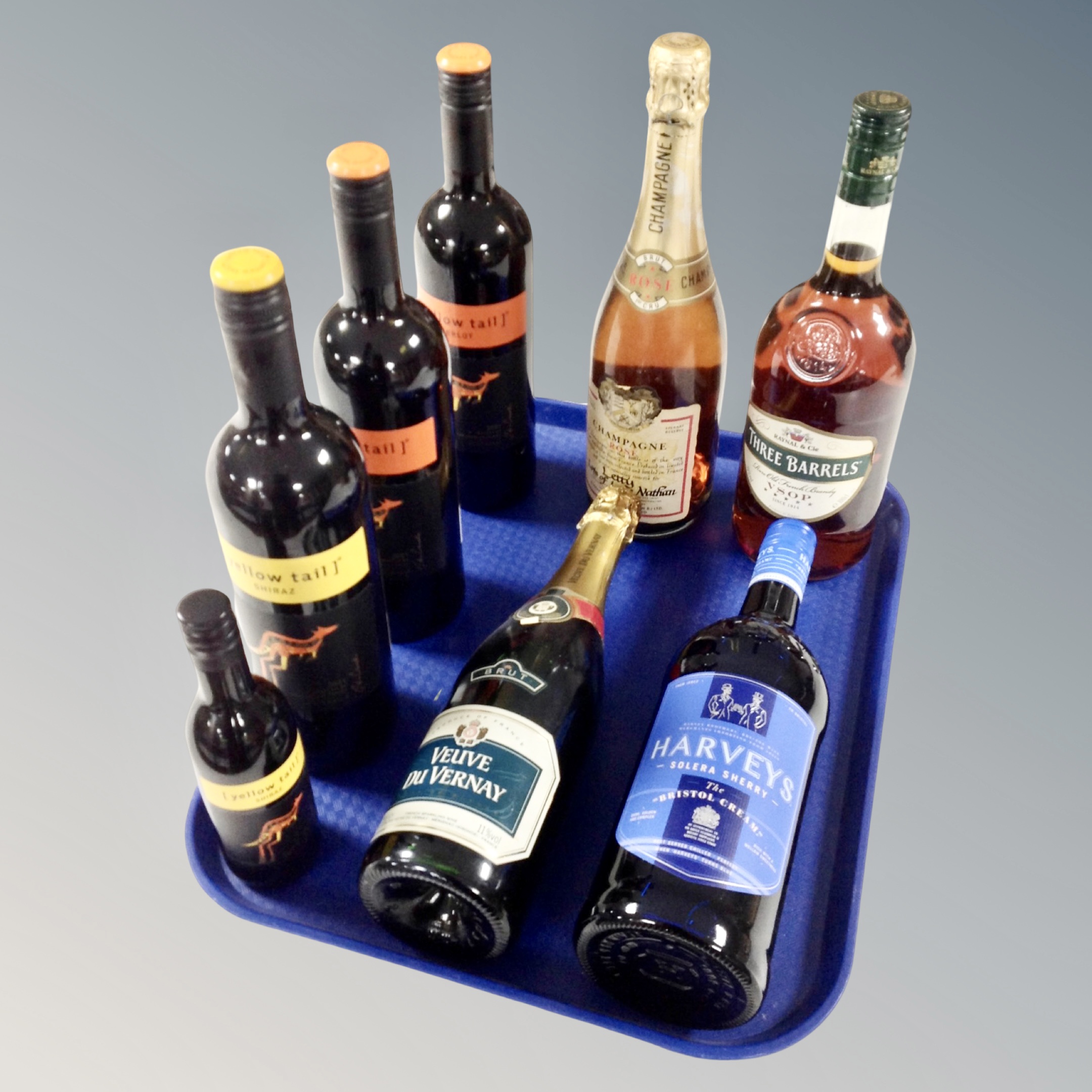 A tray of eight bottles of alcohol to include Veuve Du Vernay brut, three barrels French brandy,