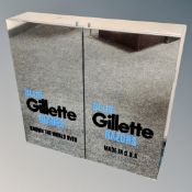 A contemporary double door mirrored cabinet bearing Gillette advertising
