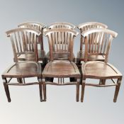 A set of six stained hardwood rail backed dining chairs