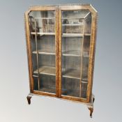 A 1930's Art Deco oak double door bookcase with glazed doors