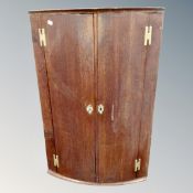 A George III oak barrel fronted double door cabinet