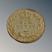 A silver 1889 six pence piece