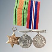 Three WW II medals on two ribbons.