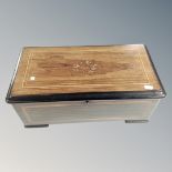 A 19th century inlaid rosewood table top Swiss music box