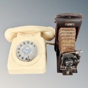 A cream bakelite cased rotary dial telephone together with a carbine vintage camera