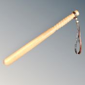 A wooden truncheon with leather strap