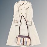 A Burberry beige trench coat together with a Burberry cross body hand bag CONDITION