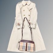 A Burberry beige trench coat together with a Burberry cross body hand bag CONDITION