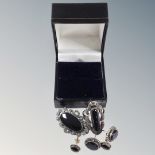A collection of white metal and onyx Art Deco style jewellery to include two pairs of earrings,