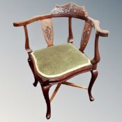 An Edwardian corner armchair