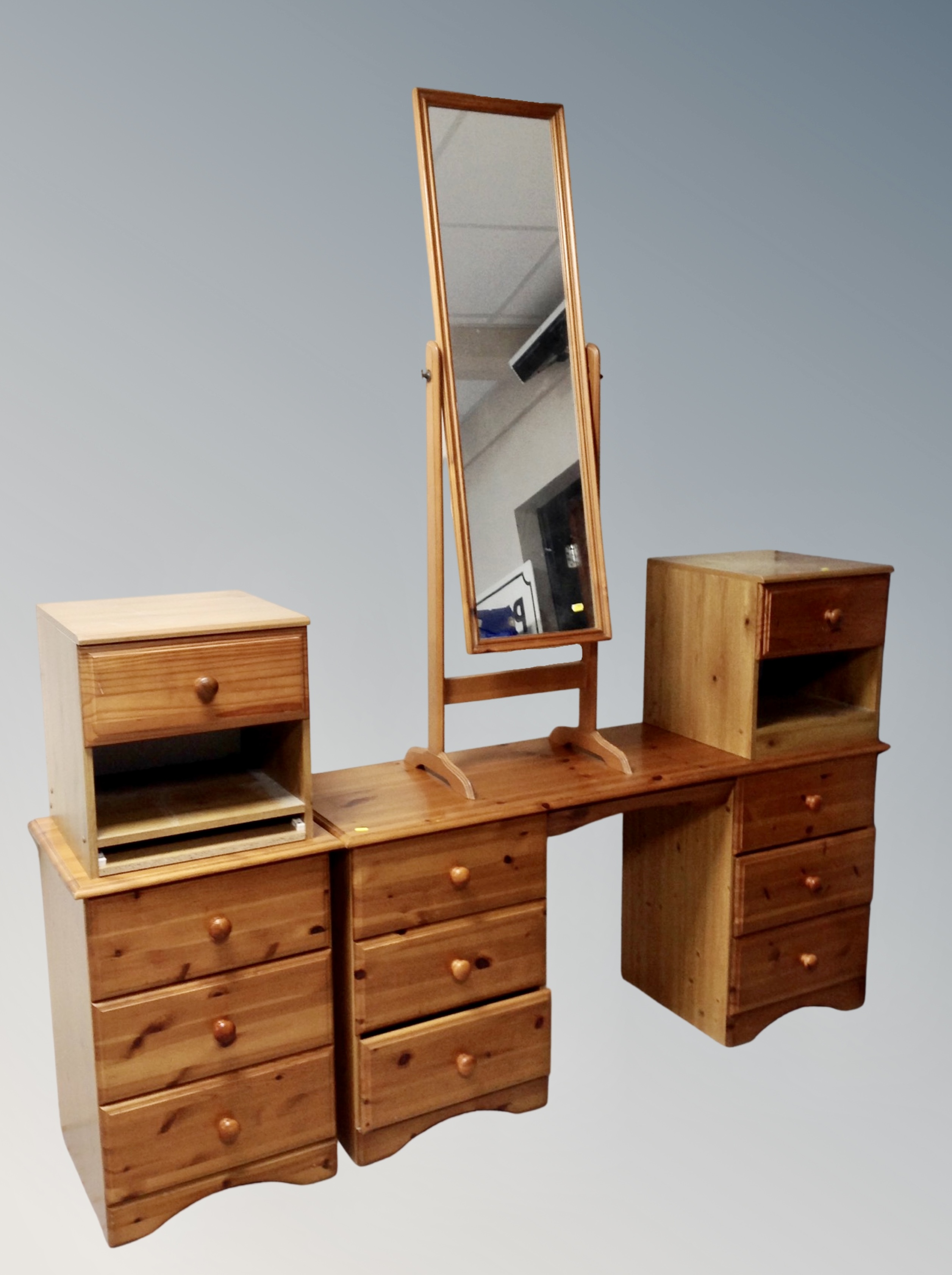 A contemporary pine six drawer knee hole dressing table with matching three drawer chest,