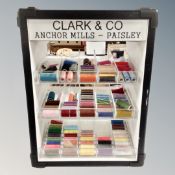 A haberdashery cabinet bearing Clark and Company Anchor mills advertising and quantity of