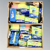 Two boxes of turbo trax vehicles and play sets,