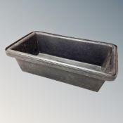 Two black plastic troughs,