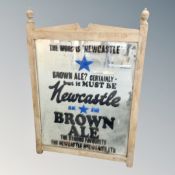 An antique pine framed mirror depicting Newcastle Brown Advertising,