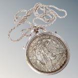 An American silver dollar mounted and with chain