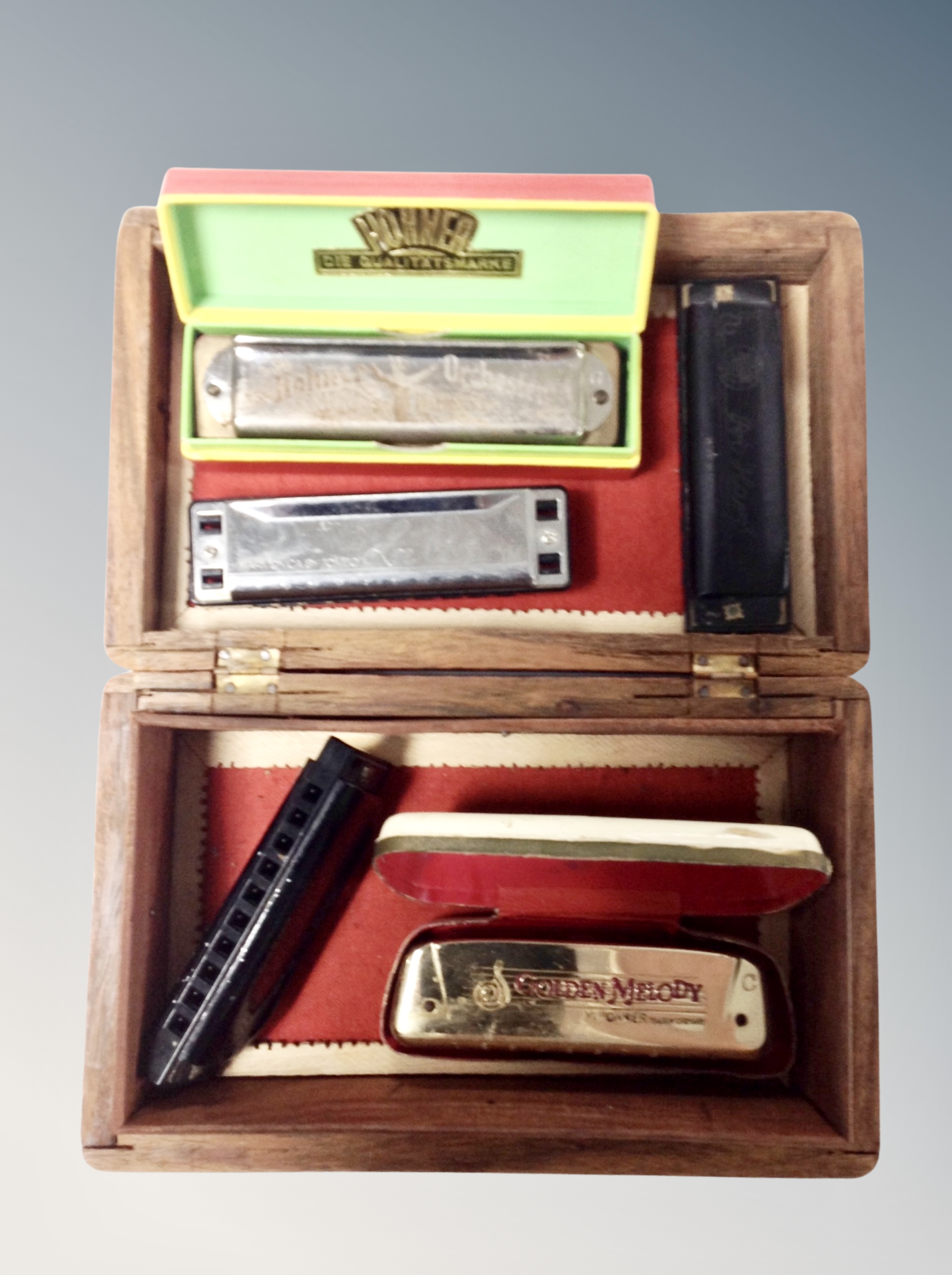 A group of four Hohner harmonicas together with a further Tombo example.