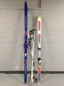 Two sets of skis by Fischer and Rossignol and a bundle of ski poles.