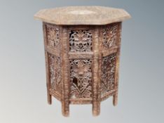 A carved Indian octagonal occasional table