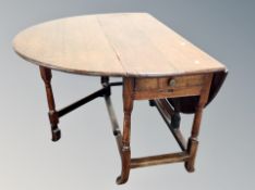 A 19th century oak drop leaf dining table