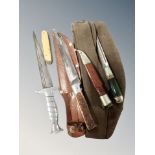 Four assorted knives and a military cap.