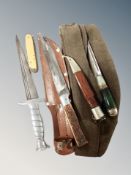 Four assorted knives and a military cap.