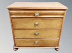 A 19th century oak four drawer chest with brass drop handles (feet a/f)