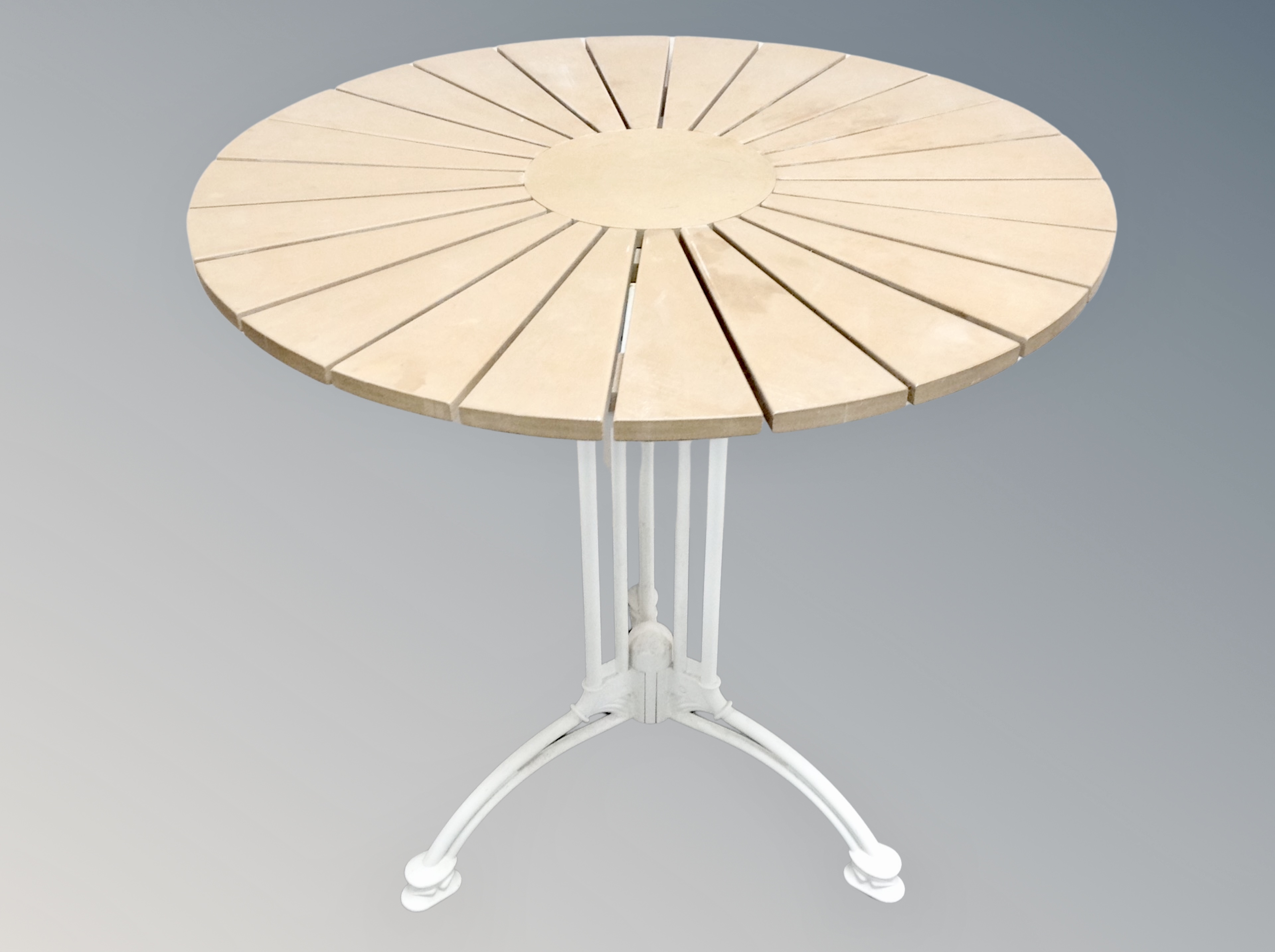 A circular garden table on cast metal support,