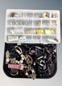A box containing assorted costume jewelry, bead necklaces and earnings etc.