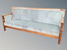 An early 20th century mahogany framed four seater salon settee in duck egg blue dralon upholstery