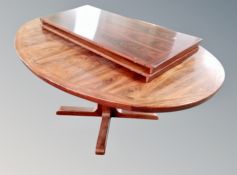 A Scandinavian rosewood effect oval extending table with two leaves,