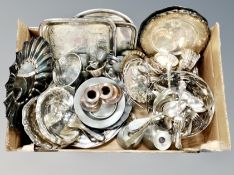 A box of silver plated wares including serving trays pin dishes, candlesticks, cutlery.