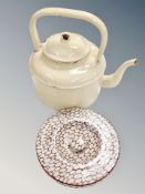 An antique enamelled kettle together with a ceramic cobble stoned jar lid