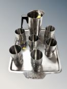 A stainless steel drinks tray with matching water jug and six cups