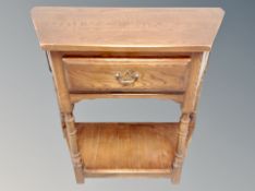 A shaped oak side table fitted a drawer,