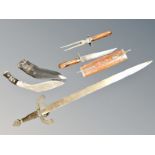 A Kukri knife in sheath, a sword and two further knives in wooden sheath.