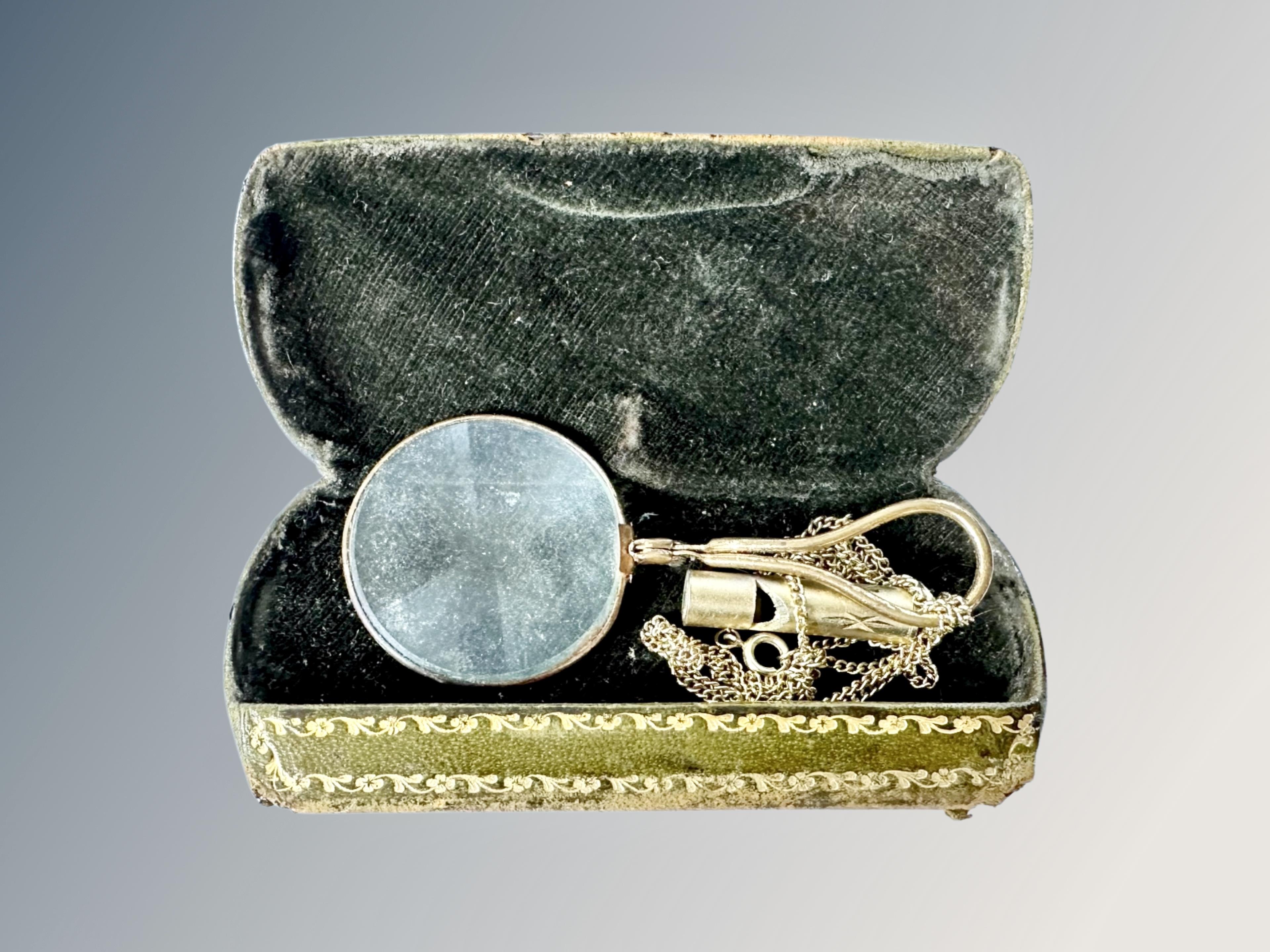 A 19th century tooled leather spectacles case containing a monocle.