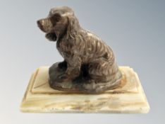 A figure of a Spaniel on onyx base,