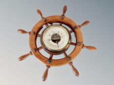 A carved barometer in the shape of a ship's wheel