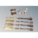 Four continental silver-handled knives, napkin ring stamped 830,